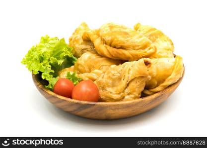 Curry Puffs, Tomatoes and Lettuce in a wooden bowl on white background