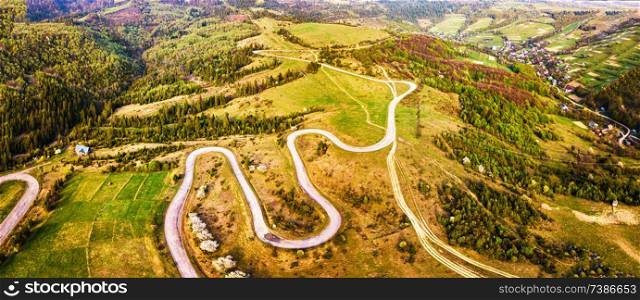 Curved bending Serpentine road on the hills. Winding alpine road in mountains. Carpathians, Ukraine