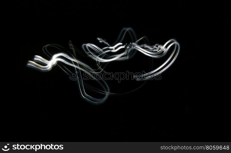 Curved blue and white lines. Abstract wave forms of light in long exposure.