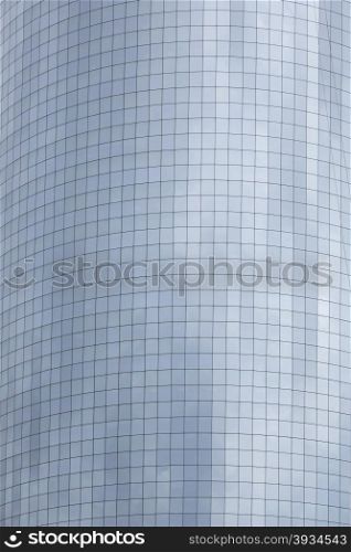 curved facade of skyscraper with reflections of clouds and sky in new york downtown manhattan