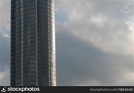 Curved Glass Office Building with Grey Clouds