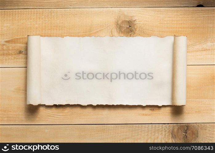 curved or scrolled paper on wooden background texture