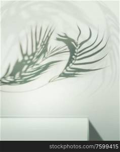 Curved tropical palm leaves shadow about podium or shelf at light blue background. Place for your product