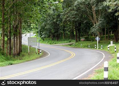 curves road in countryside with tropical green forest