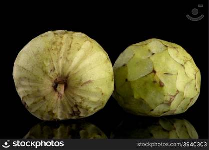 Custard apple, also known as Bullocks or Bulls Heart.On black with reflection.