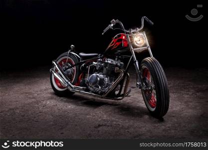 Custom bobber motorbike. Vintage style motorcycle in an workshop garage.. Custom bobber motorbike in an workshop garage.
