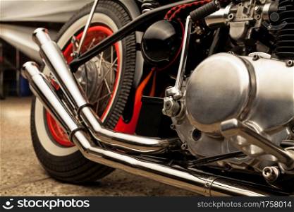 Custom bobber motorbike. Vintage style motorcycle in an workshop garage.. Custom bobber motorbike in an workshop garage.