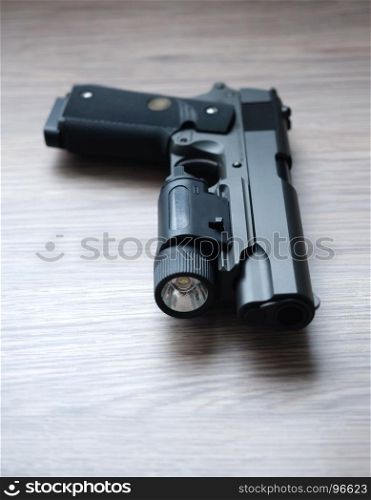 Custom build tactical .45 caliber pistol with weapon light.Shallow depth of field