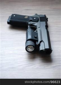 Custom build tactical .45 caliber pistol with weapon light.Shallow depth of field