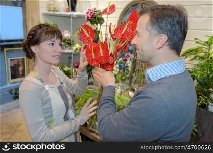 Customer and florist looking at anthurium