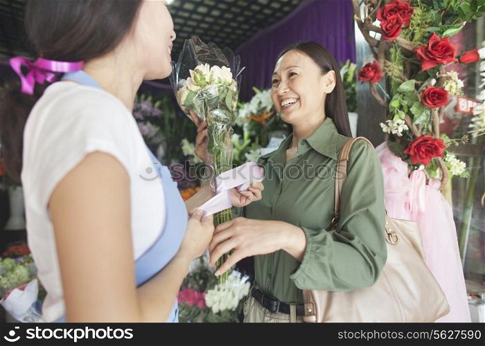 Customer Buying Bunch Of Flowers In Flower Shop