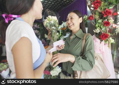 Customer Buying Bunch Of Flowers In Flower Shop