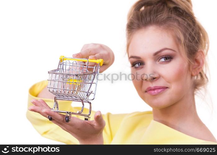 Customer buying in shop. Happy woman holding small tiny shopping cart trolley about to buy products.. Woman holding shopping cart
