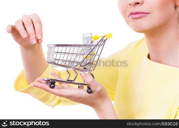 Customer buying in shop. Woman holding small tiny shopping cart trolley about to buy products.. Woman holding shopping cart