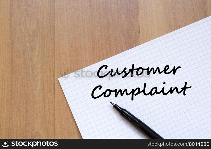 Customer complaint text concept write on notebook with pen