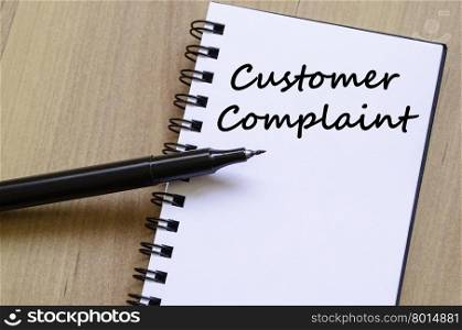 Customer complaint text concept write on notebook with pen