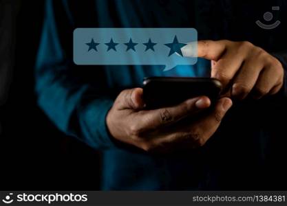 Customer Experiences Concept. a Modern Man Giving a Star Rating for Positive Review via Smartphone. Client&rsquo;s Satisfaction Surveys on Mobile Phone. Front View