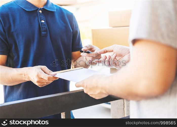 Customer Man signature in clipboard to receive package from professional delivery man at home