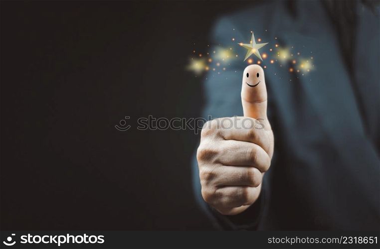 Customer satisfaction concept. Hand with thumb up Positive emotion smiley face icon and five star with copy space.