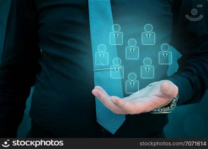 Customer service and care,care for employees,marketing niche segmentation concepts,man holding people icons in his hand.. Customer service and care,care for employees,marketing niche segmentation concepts man holding people icons in his hand