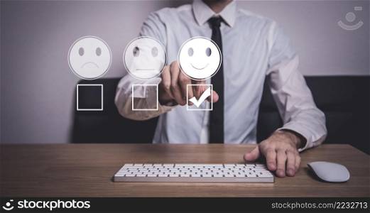 Customer service and Satisfaction concept ,Businessman are touching the virtual screen on the happy Smiley face icon to give satisfaction in service