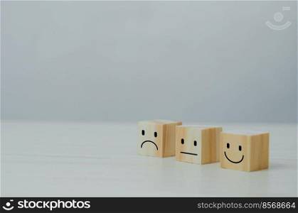 Customer service and Satisfaction concept happy Smiley face icon.Business feedback positive rating very impressed wood cube on table.