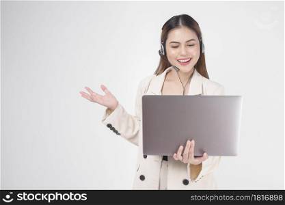Customer service operator woman in suit wearing headset over white background studio