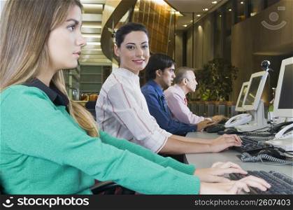 Customer service representatives working in an office