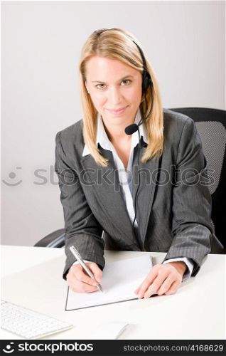 Customer service woman call operator phone headset sitting behind desk