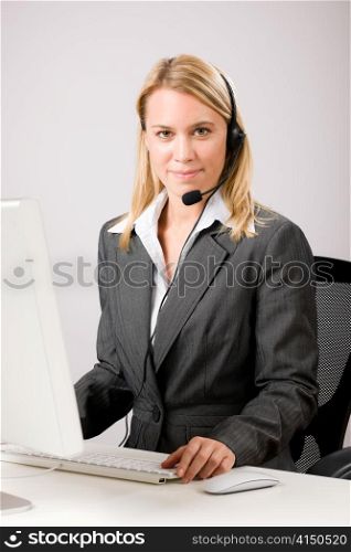 Customer service woman call operator phone headset working on computer