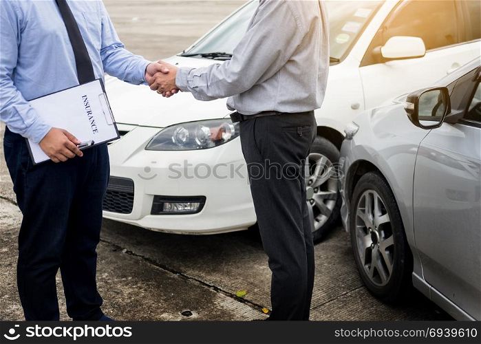 Customer shake hand with auto insurance agents after agreeing to terms of insurance.