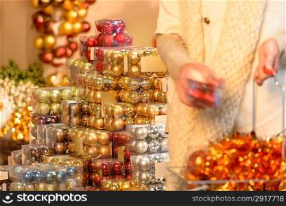 Customer shopping Christmas decorations balls putting to shopping basket