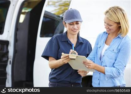 Customer Signing For Delivery From Female Courier