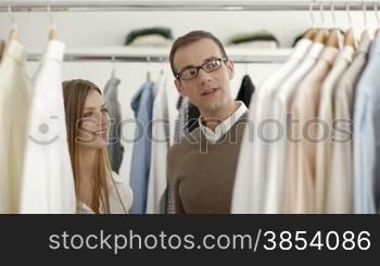 Customer speaking to sales manager in fashion store while shopping for clothes
