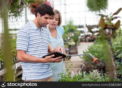 Customer using a digital tablet in greenhouse