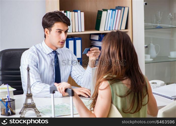 Customer visiting travel agency and talking to agent