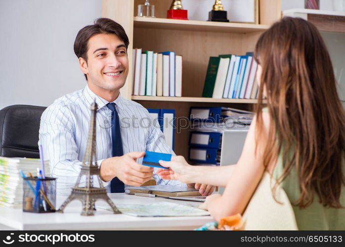 Customer visiting travel agency and talking to agent