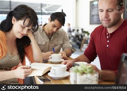 Customers In Busy Coffee Shop