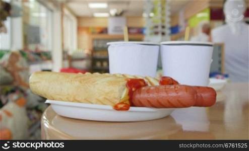 Customers ordered fast-food snack hot dogs and drinks in convenience store