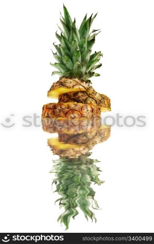 cut ananas reflected in water