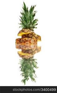 cut ananas reflected in water