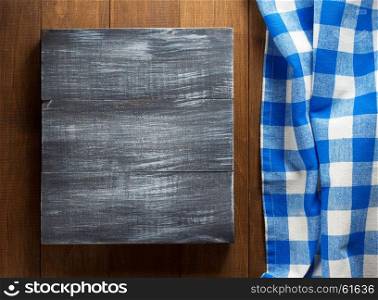 cut board and napkin on wooden background