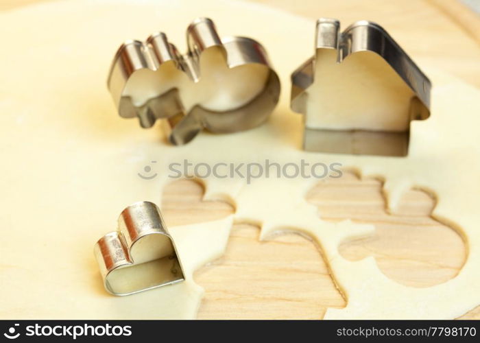 cut dough snowman, house, heart, and forms for cookies