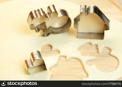 cut dough snowman, house, heart, and forms for cookies