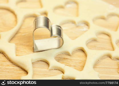 cut dough snowman, house, heart, and forms for cookies