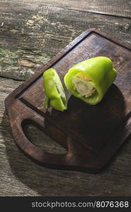 Cut green pepper on wood. Backlight