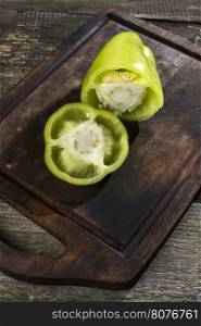 Cut green pepper on wood. Backlight