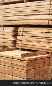 Cut in boards and trim for sale pine wooden material closeup in lumberyard