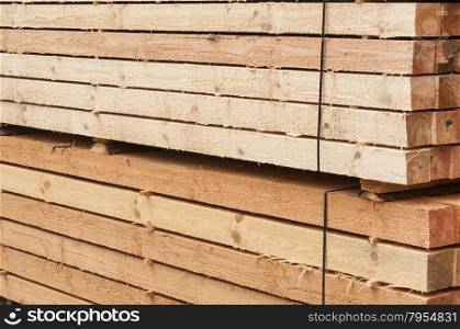 Cut in boards and trim for sale pine wooden material closeup in lumberyard