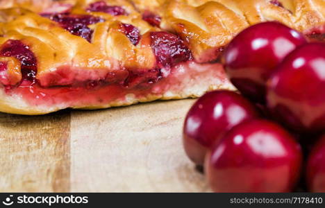 cut into pieces cherry wholesome pie made at home for the holiday, close-up of baking and berries. cherry wholesome pie